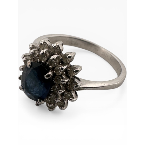26 - Sapphire and Diamond Cluster Ring set in White Metal. Unmarked. Size O. 3.63g...