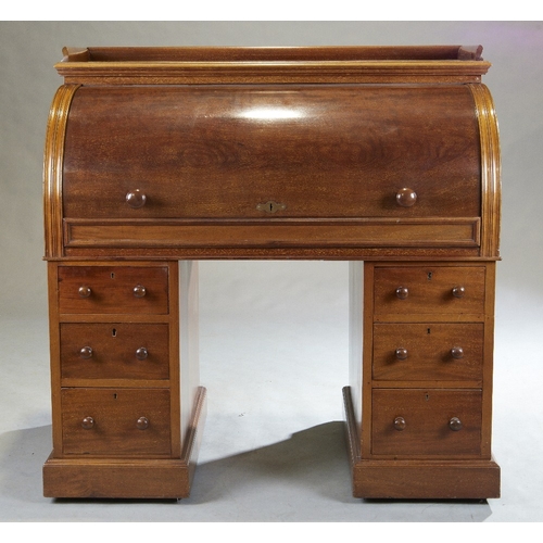 147 - A Victorian mahogany roll top pedestal desk, last quarter 19th century, the gallery top above rollin... 