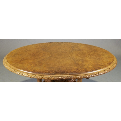 149 - A Victorian walnut centre table, third quarter 19th century, the oval top above four scrolling suppo... 