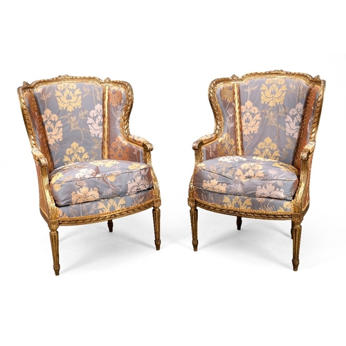 196 - A French giltwood salon suite, of Louis XVI style, last quarter 19th century, comprising a sofa, two... 