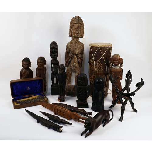 28 - A collection of African artefacts, 20th century, to include a group of figural statues, the tallest ... 