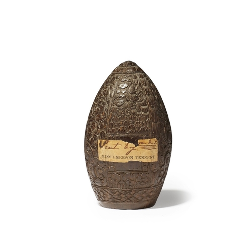 29 - An ogival and hollowed carved endocarp of an unknown fruit, 19th / 20th century, the floral and leaf... 