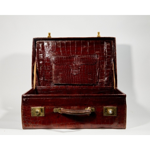 59 - Two brass-mounted brown crocodile leather travelling cases, early 20th century, the first by Leuchar... 