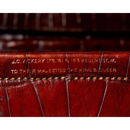 59 - Two brass-mounted brown crocodile leather travelling cases, early 20th century, the first by Leuchar... 