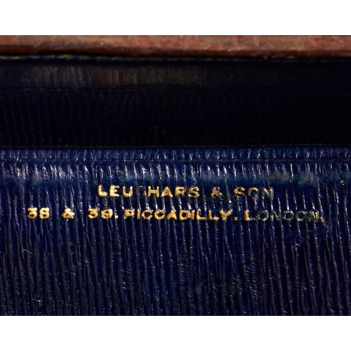 59 - Two brass-mounted brown crocodile leather travelling cases, early 20th century, the first by Leuchar... 