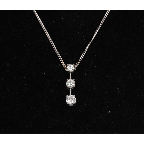 1245 - 18K WHITE GOLD AND 3 STONE DIAMOND PENDANT