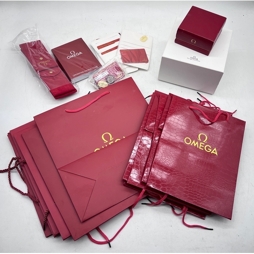 A collection of branded Omega watch sleeves, bags, boxes etc.