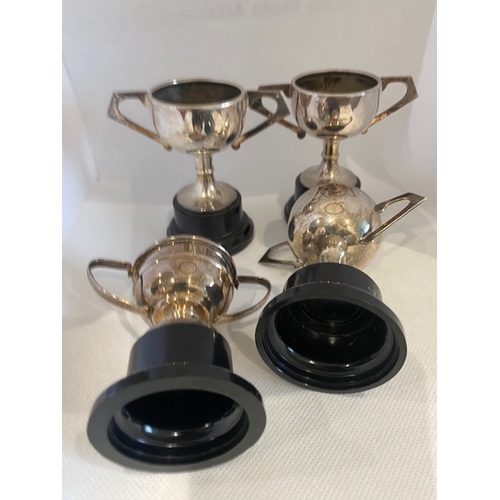 235 - Silver plated trophies (4) no engraving. Largest 8.5cm overall height