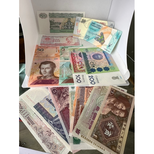 14 - 15 new uncirculated foreign world banknotes