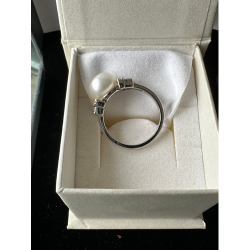 571 - Sterling Silver rhodium plated pearl ring with CZ size N/O. In original box