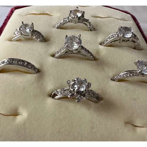 467 - 7 silver tone costume rings of engagement / solitaire style, unworn. Sizes M to U