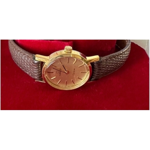 283 - OMEGA Geneve ladies watch, Swiss made, oval champagne face, gold plated case with Omega signed crown... 