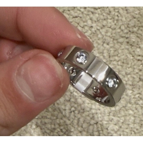 590 - silver coloured love ring, replica, no guarantees given or implied that this is made from precious m... 