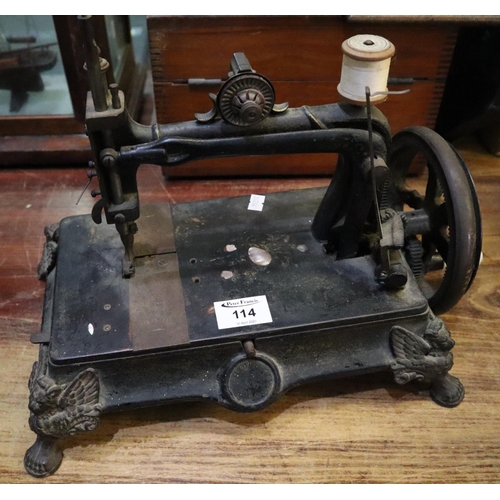 114 - Vintage hand sewing machine with open frame and base supported on winged lion feet. 
(B.P. 24% incl.... 