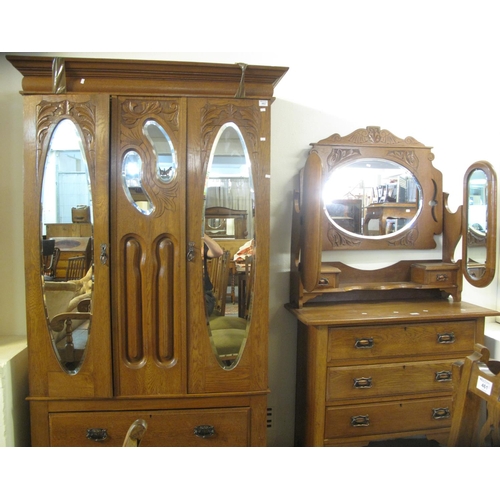 462 - Art Nouveau design oak carved bedroom suite comprising two door mirrored and bevelled wardrobe and a... 