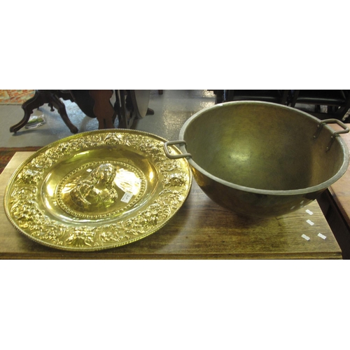 475 - Beaten brass circular two handled bowl, together with a brass repousse portrait charger. (2)
(B.P. 2... 