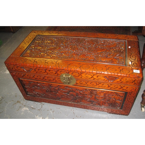 477 - Modern stained camphor wood chest, carved with dragons amongst clouds. 
(B.P. 24% incl. VAT)