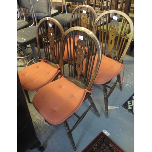 494 - Set of four mid Century stained beech hoop wheel and spindle back kitchen chairs. (4)
(B.P. 24% incl... 