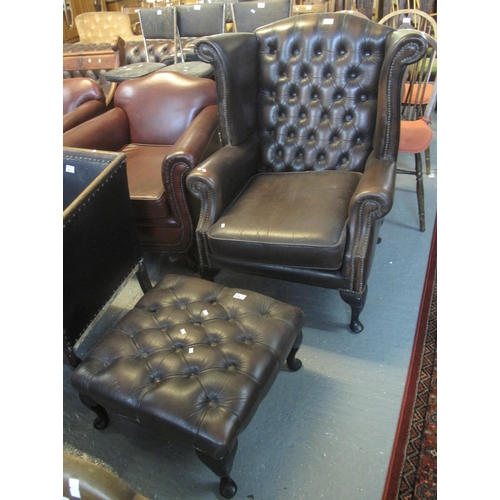 498 - Chesterfield style button back leather wing armchair with matching stool or footrest. Together with ... 