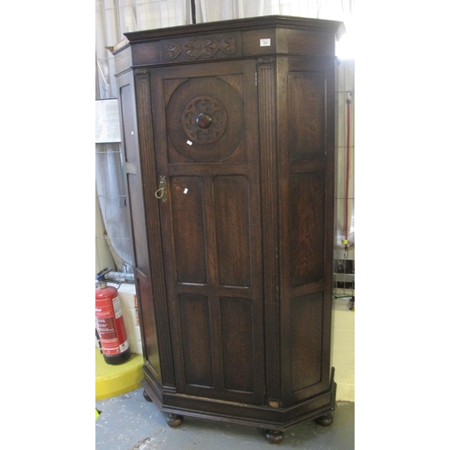 503 - Early 20th Century carved oak single door hall cupboard on pad feet. 
(B.P. 24% incl. VAT)