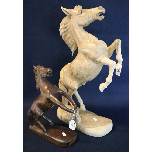 95 - Two modern carved wooden sculptures of rearing horses. 
(B.P. 24% incl. VAT)