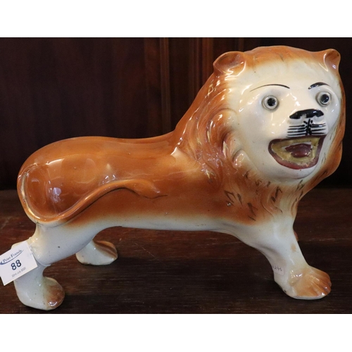 88 - Early 20th Century pottery fireside standing lion with glass eyes and painted features, unmarked. 
(... 