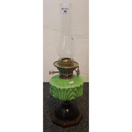 90 - Early 20th Century double burner oil lamp having glass chimney with green ceramic reservoir on a bul... 