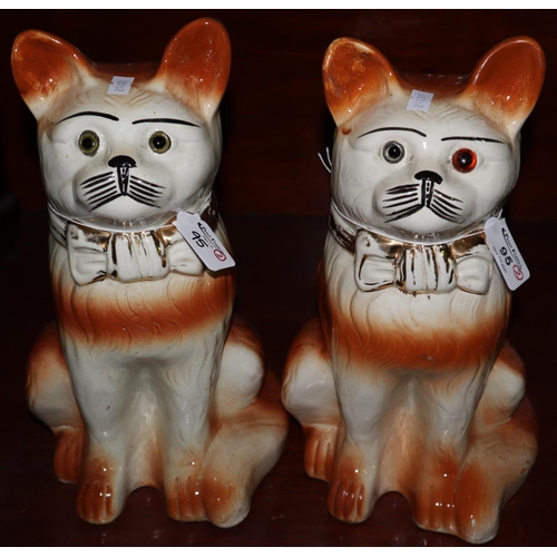 95 - Pair of early 20th Century Staffordshire pottery fireside cats with mainly replacement glass eyes. (... 