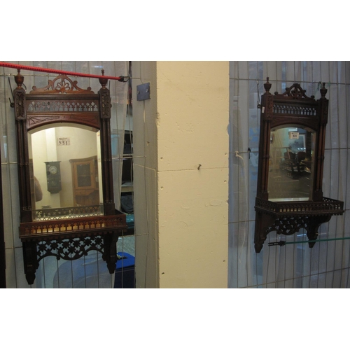 531 - Pair of Edwardian mahogany bevelled mirrors with pierced decoration and under shelves. (2)
(B.P. 21%... 