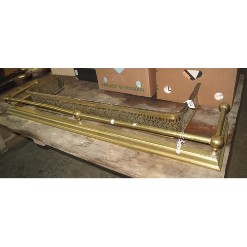 554 - Two brass fire fenders one with pierced decoration.
(B.P. 21% + VAT)