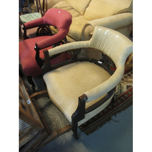 512 - Two similar Edwardian ebonised and upholstered tub chairs on cabriole legs with ceramic casters. (2)... 