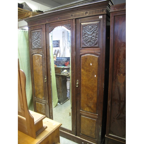 554 - Edwardian mahogany and walnut three door wardrobe with mirror centre, hanging and base and shelves.
... 