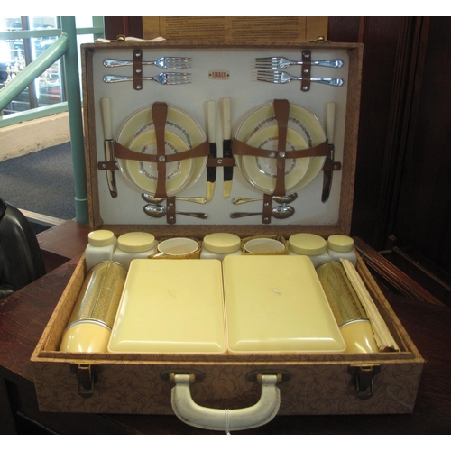 86 - A Sirram-cased picnic set, fully fitted to the interior with cutlery, china, storage jars, sandwich ... 