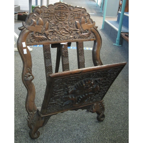 95 - Oriental carved hardwood folding folio or magazine stand overall decorated with fantastic animals an... 