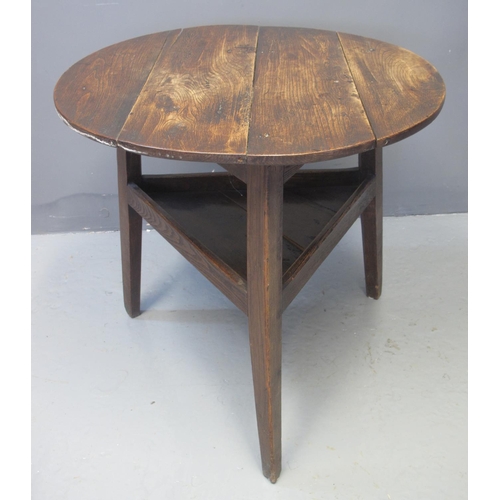 61 - 19TH CENTURY TRADITIONAL WELSH OAK CRICKET TABLE with under shelf. 74cm diameter, 70cm high approx. ... 