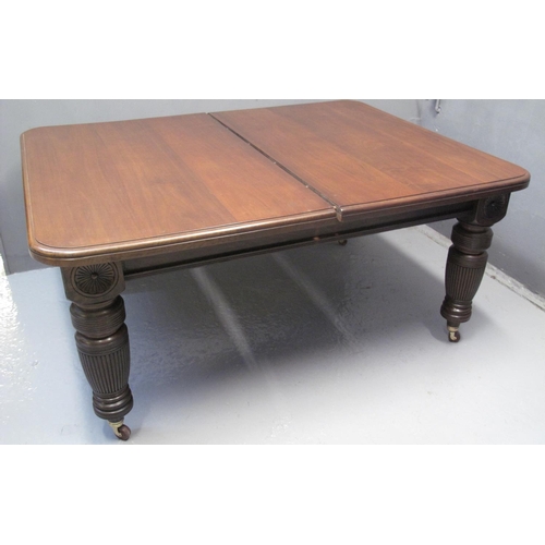 67 - VICTORIAN WALNUT EXTENDING DINING TABLE with three additional leaves, the moulded top with flower he... 