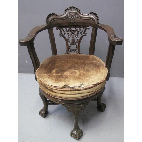 82 - LATE VICTORIAN WALNUT SWIVEL OPEN ARMCHAIR, the carved back with pierced ribbon and tassel decoratio... 