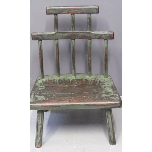 83 - UNUSUAL PRIMITIVE CHILD'S CHAIR having moulded slab seat standing on chamfered legs with remnants of... 