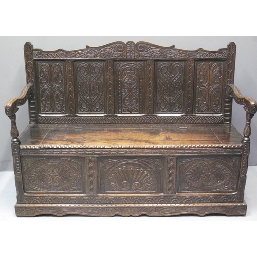 84 - 17TH CENTURY STYLE STAINED OAK SETTLE having carved scroll foliate back above five carved and fielde... 