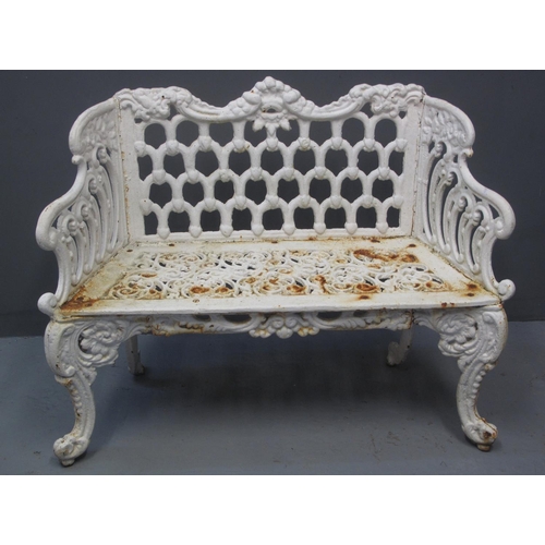 97 - 19TH CENTURY HEAVY CAST IRON TWO SEATER GARDEN BENCH having pierced decoration to the back, sides an... 