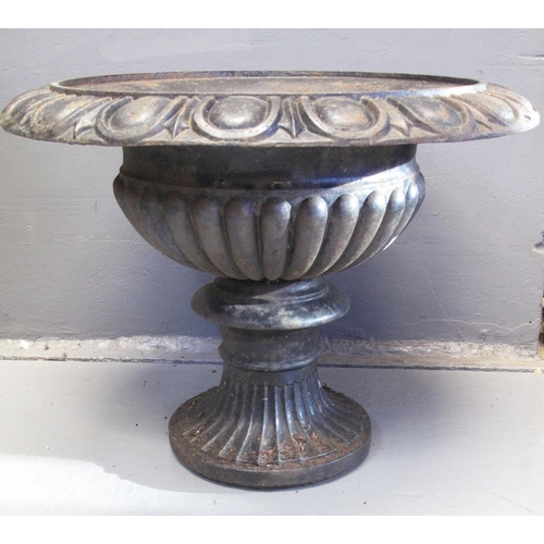 98 - VICTORIAN CAST IRON GARDEN URN of fluted form on circular base. 48cm high, 61cm diameter approx.
(B.... 