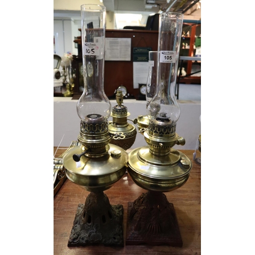 105 - Two similar brass oil lamps with cast iron pierced bases and clear chimneys. (2)
(B.P. 21% + VAT)