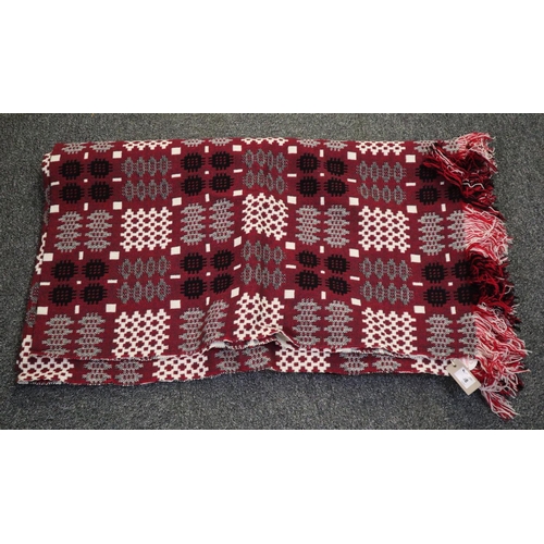 108 - A vintage red ground Welsh tapestry blanket with fringed edging with a 'Made in Mid Wales' label att... 