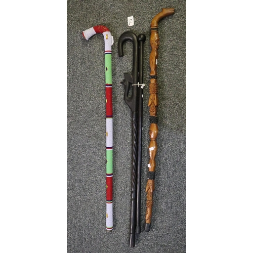 112 - Bundle of decorative walking sticks, African ebony sticks, carved, moulded, beaded etc.
(B.P. 21% + ... 