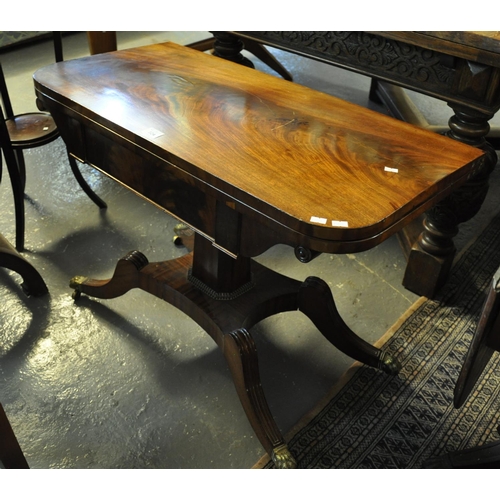 524 - 19th Century mahogany folding card table on quatreform base with brass paws and casters.
(B.P. 21% +... 