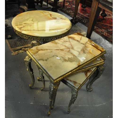 525 - Onyx and gilded brass items to include; circular lamp table and a nest of three tables.
(B.P. 21% + ... 