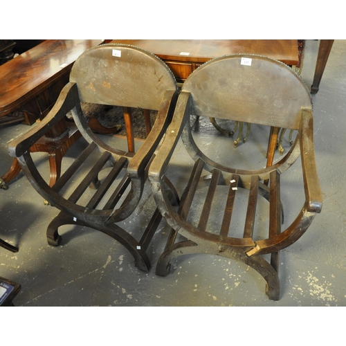 527 - A pair of Savonarola style oak chairs with padded backs and metal stud work (AF).
(B.P. 21% + VAT)