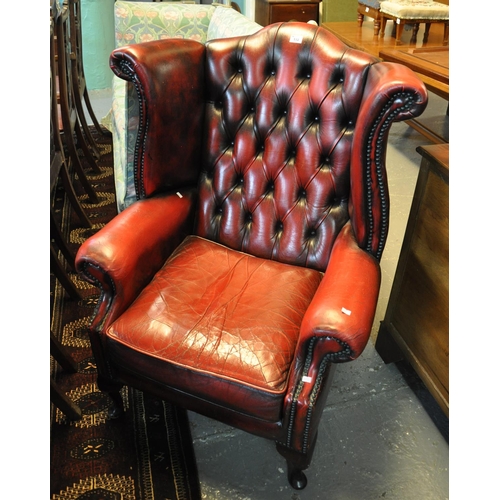 532 - Oxblood leather Chesterfield style button back wing chair.
(B.P. 21% + VAT)