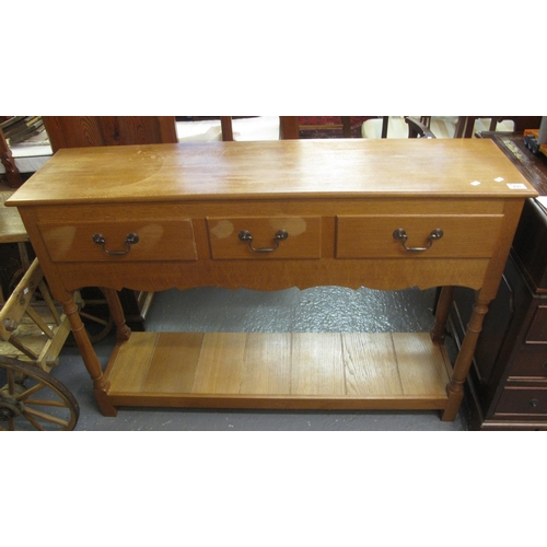 537 - Reproduction oak dresser base having moulded top above three drawers. 
(B.P. 21% + VAT)