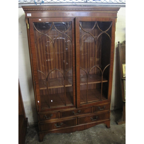 541 - Reproduction mahogany two door glazed bookcase, having moulded dentil cornice and an arrangement of ... 